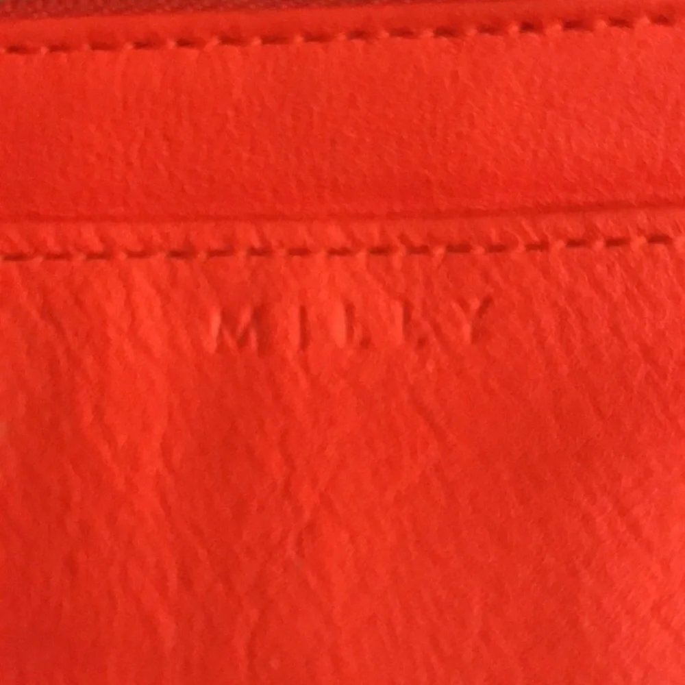 Milly wristlet orange mobile wallet front snap ,zip  lots of pockets